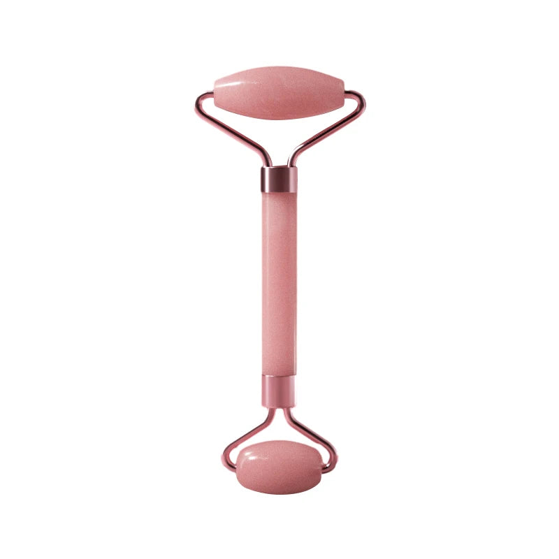 Pink facial roller on a white background